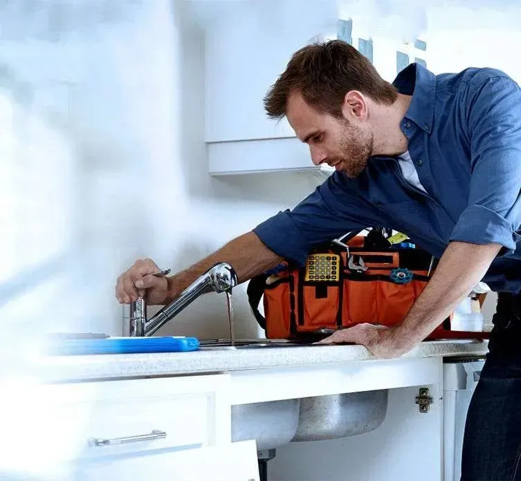 A professional utility crew installing large-diameter underground gas pipes in a Dallas residential neighborhood trench.