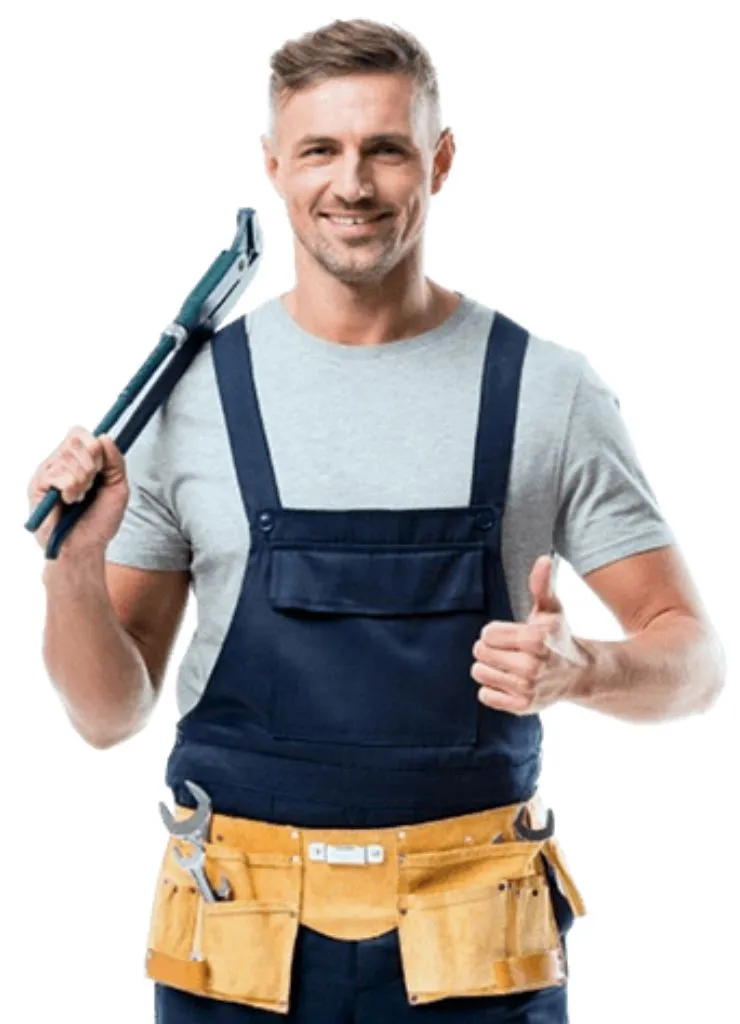 A Dallas plumber in a blue uniform using a red wrench to secure an orange gas line for a tankless water heater installation.
