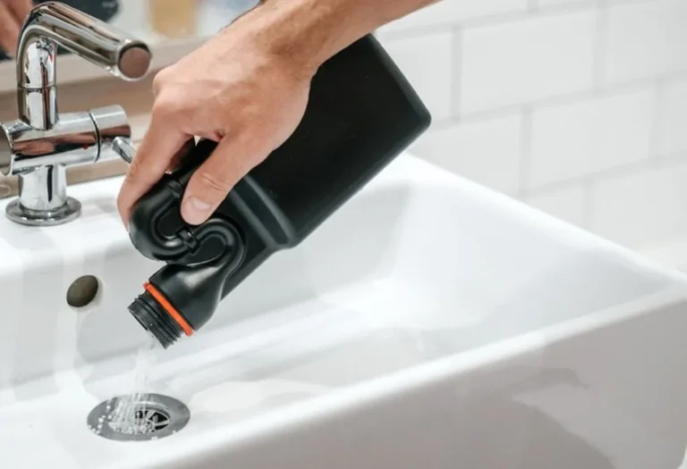 Technician clearing a main sewer line in Dallas with a professional snake tool.